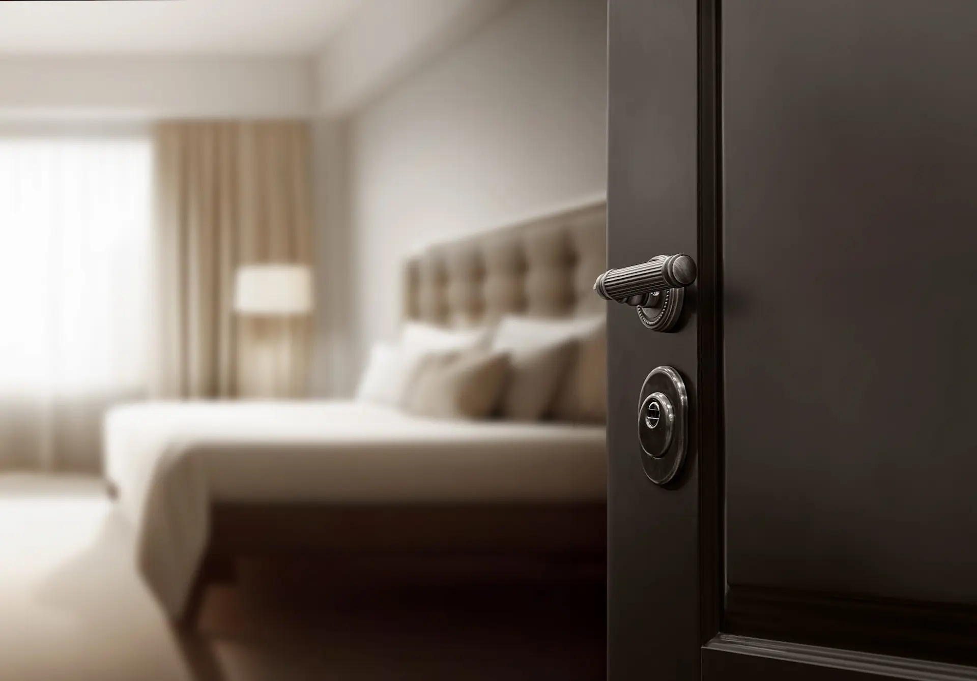 A door opens onto a warmly lit suite at The Tel