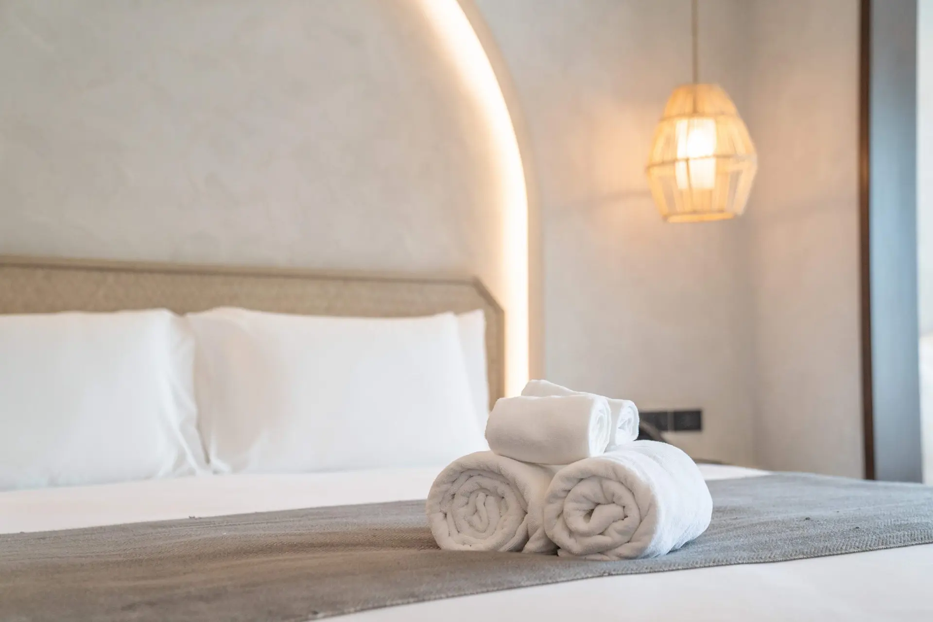 Fresh rolled towels on a bed, a small boutique touch at The Tel